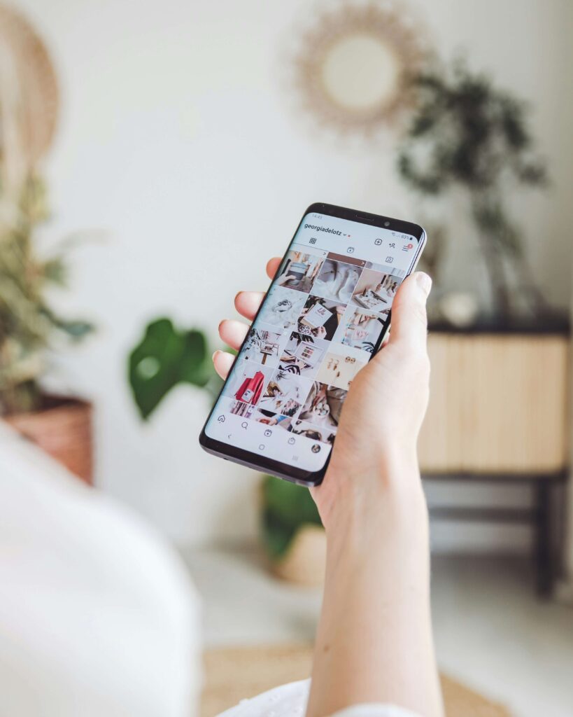 woman on phone looking at instagram feed